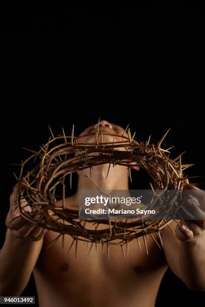 man holding a crown of thorns - asian man covering ears stock pictures, royalty-free photos & images