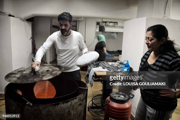 Refugee from Iraq makes pita bread at the collective "Roots-farm to table" restaurant in the centre of Athens on March 9, 2018. Salman Dakdouk...