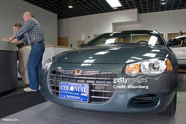 John and Evelyn Marshall wait to pick up a Chrysler 300C at Colonial Chrysler in Watertown, Massachusetts, Thursday, June 22, 2006. DaimlerChrysler...