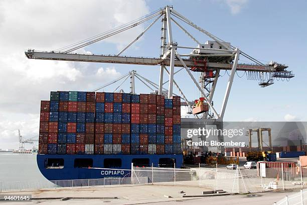 Crane lifts containers onto the "Copiapo" container ship, at the Port of Le Havre, in Seine Maritime, France, on Thursday, November 2, 2006. The ship...