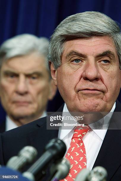 Republican Senator John Warner of Virginia, looks on at left, as Senator Ben Nelson of Nebraska speaks at a news conference on Capitol Hill, Jan. 22,...