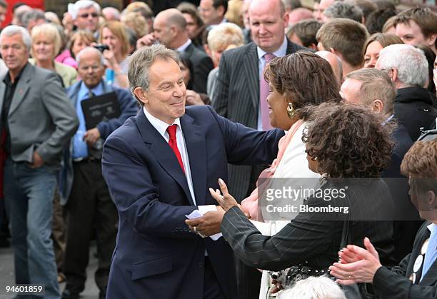 Prime Minister Tony Blair shakes hands with supporters following the announcement of his resignation at the Trimdon Labour Club in Sedgefield, U.K....