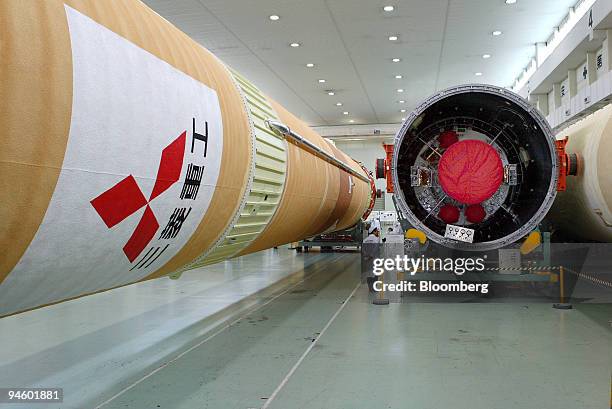 Journalists inspect an H2A rocket during a media tour of Mitsubishi Heavy Industries' Ohe plant in Aichi prefecture, central Japan, on Thursday, June...