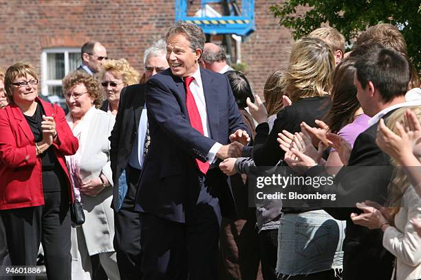 Prime Minister Tony Blair shakes hands with supporters before the announcement of his resignation at the Trimdon Labour Club in Sedgefield, U.K....