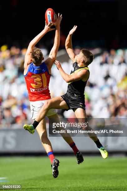 Harris Andrews of the Lions and Dan Butler of the Tigers contest a mark during the round four AFL match between the Richmond Tigers and the Brisbane...