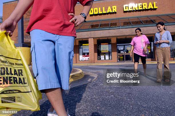 Mauro Delgado, left, exits a Dollar General store in Sandy Springs, GA with his mother, Epifania Salazar, center, and sister Maria Delgado on Monday...