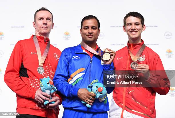 Silver medalist Grzegorz Sych of Canada, gold medalist Sanjeev Rajput of India and bronze medalist Dean Bale of England pose after the Men's 50m...