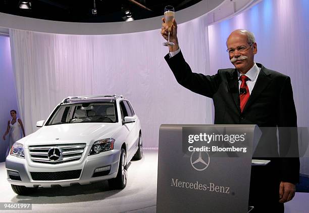 Deiter Zetsche, chief executive officer of Daimler AG, raises a glass during the debut of the Mercedes-Benz Vision GLK Freeside, left, at the Museum...