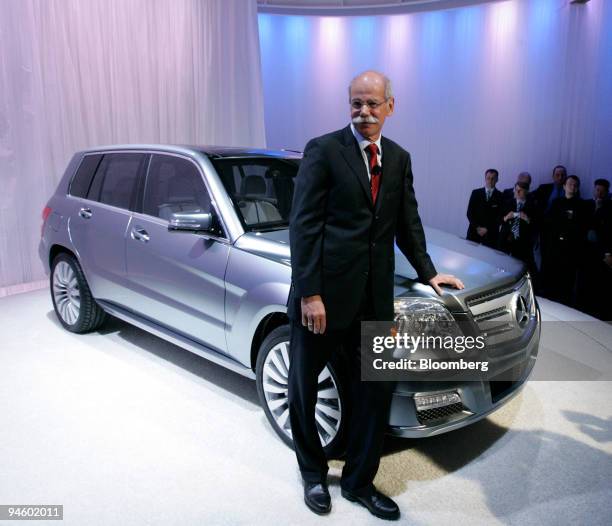 Deiter Zetsche, chief executive officer of Daimler AG, poses with a Mercedes-Benz Vision GLK following its debut at the Museum of Contemporary Art in...