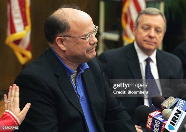 Senator Dick Durbin looks on, at right, as Ed Edmundson from New Bern, South Carolina, is comforted as he becomes emotional, while speaking during a...