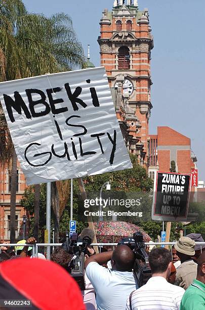 Supporters hold posters prior to the arrival of Jacob Zuma, former deputy president of South Africa, at the High Court in Pietermaritzburg, South...