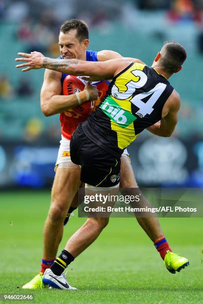 Luke Hodge of the Lions is tackled during the round four AFL match between the Richmond Tigers and the Brisbane Lions at Melbourne Cricket Ground on...