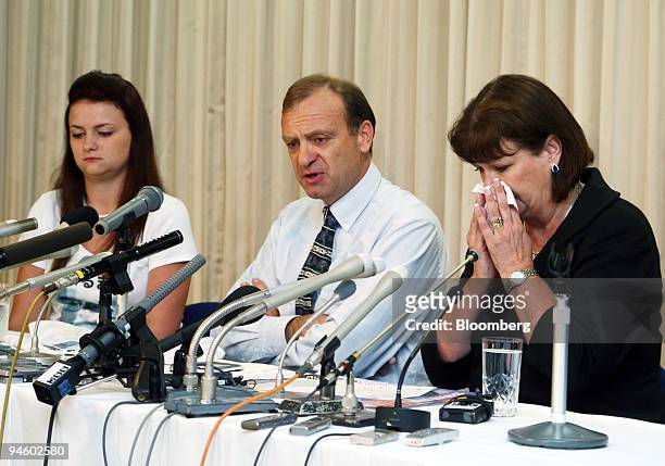 The family of murdered teacher Lindsay Hawker including Bill Hawker, center, along with his wife Julia and daughter Louise, listen to questions...
