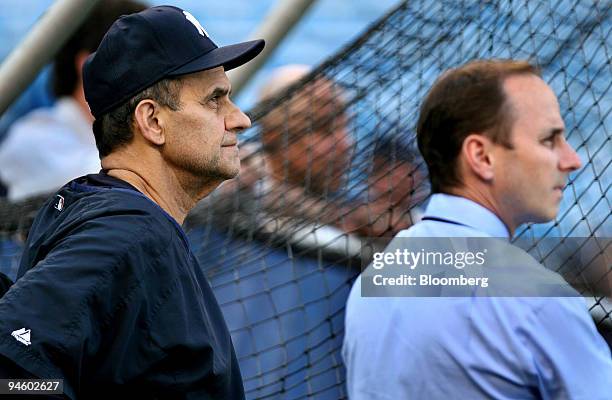 Joe Torre, manager of the New York Yankees, left, and Brian Cashman, general manager for the team, watch batting practice before the New York vs....