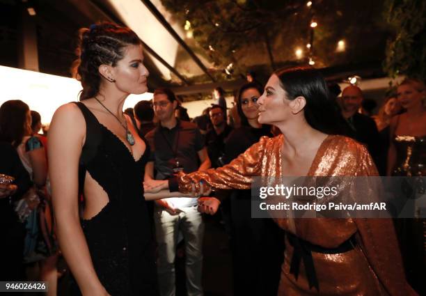 Isabeli Fontana and Cleo Pires attend the 2018 amfAR gala Sao Paulo at the home of Dinho Diniz on April 13, 2018 in Sao Paulo, Brazil.