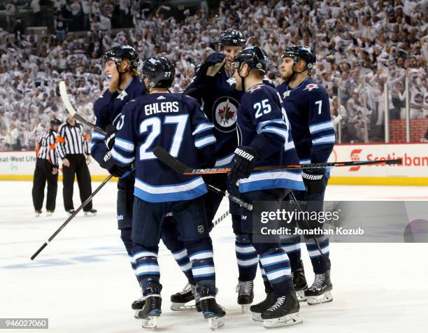 Patrik Laine, Nikolaj Ehlers, Tyler Myers, Paul Stastny and Ben Chiarot of the Winnipeg Jets celebrate a third period goal against the Minnesota Wild...