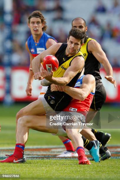 Trent Cotchin of the Tigers handballs during the round four AFL match between the Richmond Tigers and the Brisbane Lions at Melbourne Cricket Ground...
