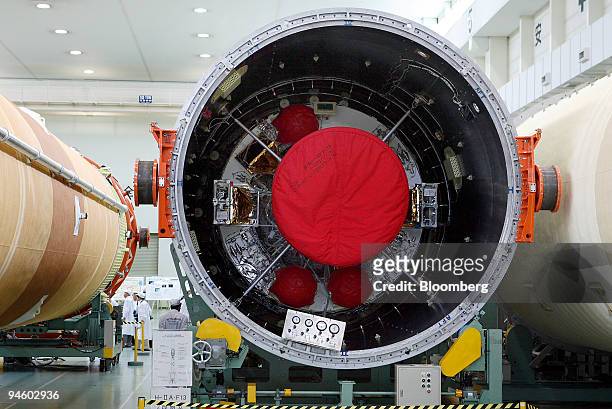 Journalists inspect an H2A rocket during a media tour of Mitsubishi Heavy Industries' Ohe plant in Aichi prefecture, central Japan, on Thursday, June...