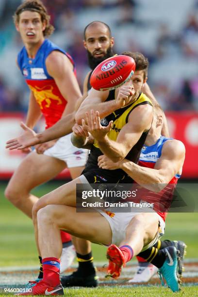 Trent Cotchin of the Tigers handballs during the round four AFL match between the Richmond Tigers and the Brisbane Lions at Melbourne Cricket Ground...