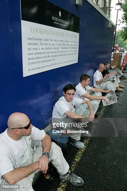 Construction workers take a break outside the InterContinental Hotel at London Park Lane, which is undergoing renovation until the autumn of 2006, in...
