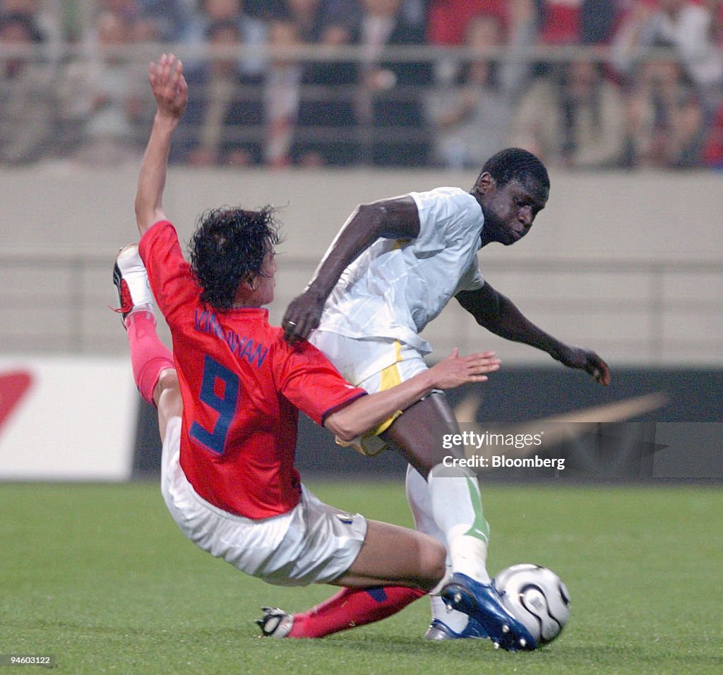 South Korean soccer player Ahn Jung Hwan, left, falls down i