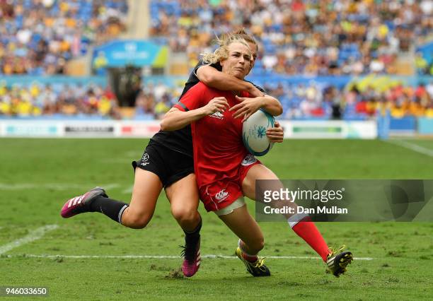 Julia Greenshields of Canada scores a try as she is high tackled by Michaela Blyde of New Zealand during Rugby Sevens Women's Pool A match between...