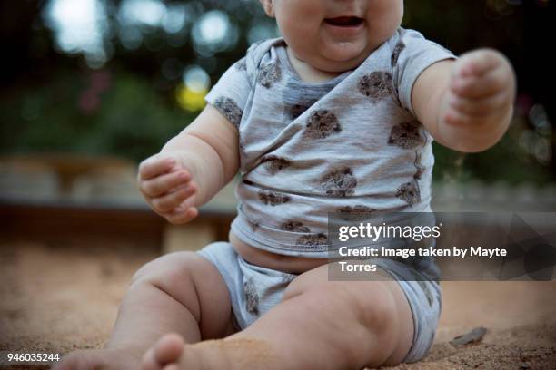 baby playing with sand at the playground - baby sandbox stock pictures, royalty-free photos & images