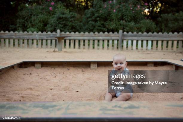 baby delighted at playground - sandkasten stock-fotos und bilder
