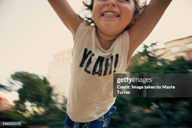 happy toddler flying at the park - baby smiling stock-fotos und bilder