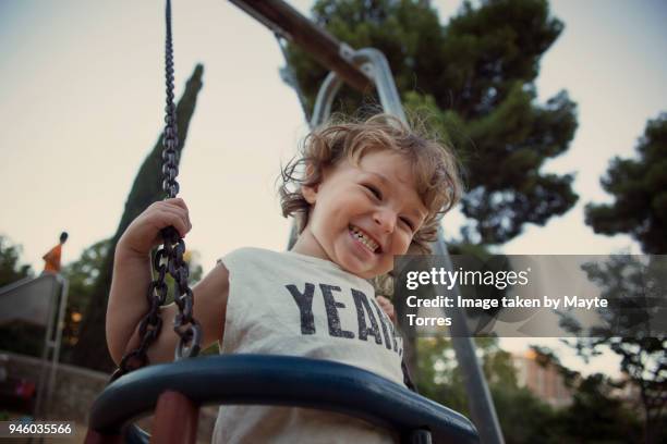 toddler at the swing laughing - toddler ストックフォトと画像