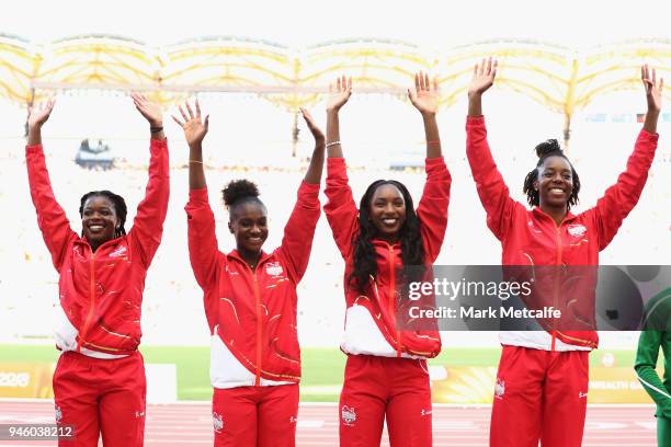 Gold medalists Asha Philip, Dina Asher-Smith, Bianca Williams and Lorraine Ugen of England celebrate during the medal ceremony for the Womens 4x100...