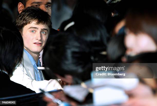 Actor Daniel Radcliffe, who plays the part of Harry Potter in the series of films of the same name, greets fans at the premiere of "Harry Potter and...