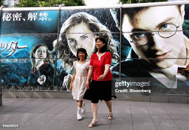 Pedestrians pass by a "Harry Potter and the Order of the Phoenix" movie poster in Tokyo, Japan, Thursday, June 28, 2007.