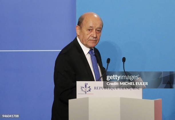 French Minister for Foreign Affairs Jean-Yves Le Drian arrives on stage to give an official statement in the press room after attending an emergency...