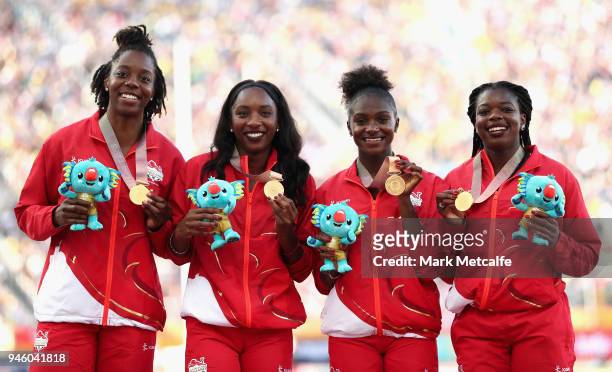 Gold medalists Asha Philip, Dina Asher-Smith, Bianca Williams and Lorraine Ugen of England celebrate during the medal ceremony for the Womens 4x100...