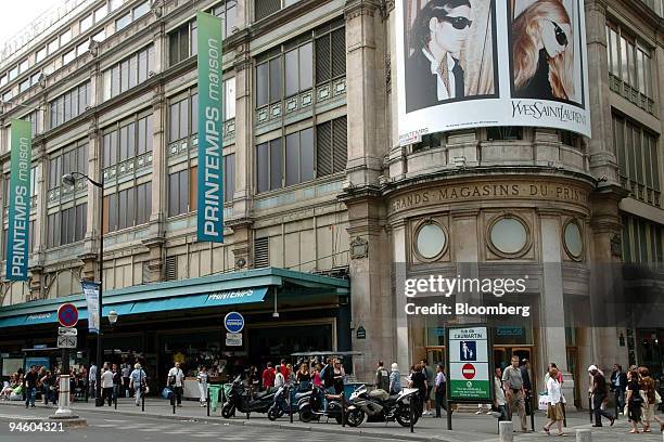Pedestrians pass a Printemps store in Paris, France, Tuesday, June 20, 2006. PPR SA, the French owner of Gucci Group NV, is in exclusive talks to...