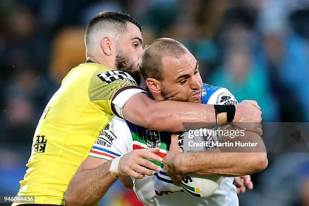 Simon Mannering of the Warriors is tackled by Jack Bird of the Broncos during the round six NRL match between the New Zealand Warriors and the...