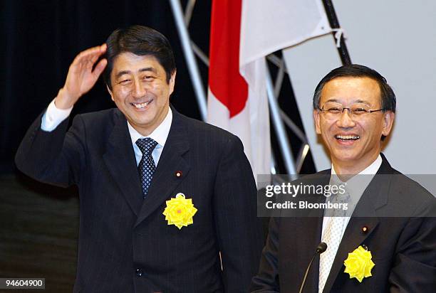 Japanese Chief Cabinet Secretary Shinzo Abe, left, and Finance Minister Sadakazu Tanigaki smile and acknowledge their audience during a convention at...