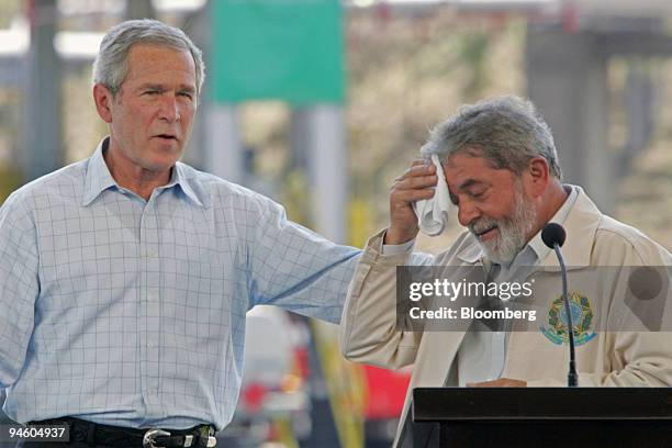 President George W. Bush, left, and Brazilian President Luiz Inacio Lula da Silva make a joint statement after a visit to a Petrobras Transporte S.A....