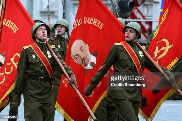 Russian soldiers parade on the Red square with Soviet flags carrying the portrait of Vladimir Lenin during the country's Victory Day Parade in...