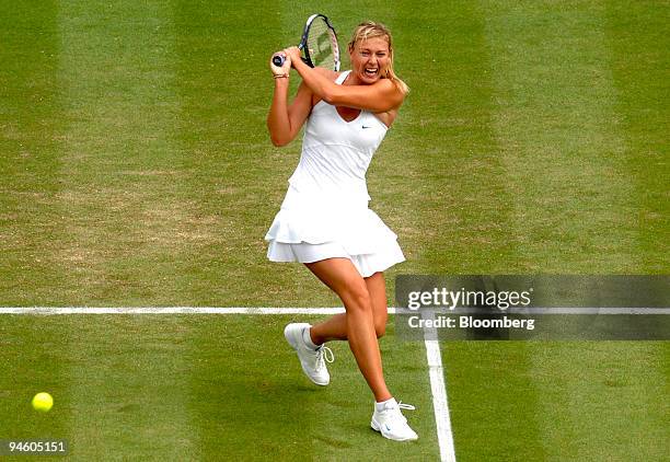 Maria Sharapova of Russia returns to Severine Bremond of France during their Wimbledon Tennis Championships match at the All England Club in London,...