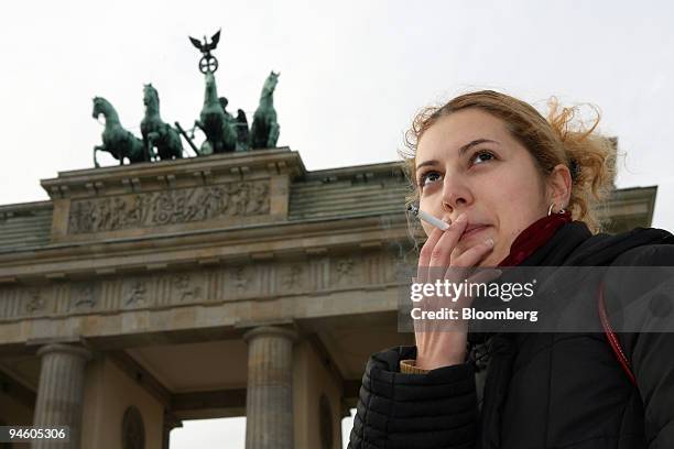 Julija Luschtschik smokes a cigarette in front of the Brandenburg Gate in Berlin, Germany, Tuesday, October 31, 2006. Berlin's freshly returned...