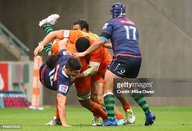 Jack Maddocks of the Rebals is tackled by Nahuel Tetaz Chaparro and Pablo Matera of the Jaguares during the round nine Super Rugby match between the...