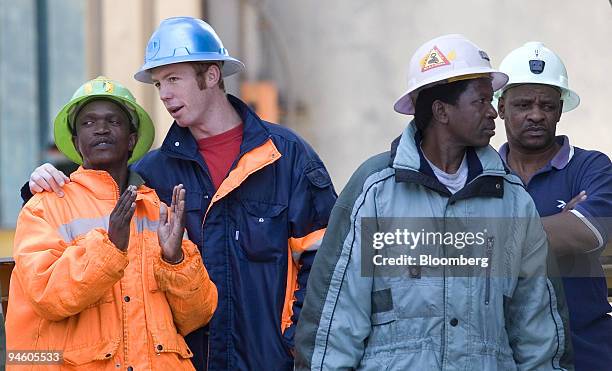 Miners watch as their colleagues are rescued and brought to the surface from the Elandsrand mine, in Carltonville, South Africa, on Thursday, Oct. 4,...