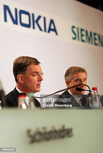 Nokia Siemens Networks incoming chief executive officer Simon Beresford-Wylie, left, speaks as Siemens chief executive officer Klaus Kleinfeld...