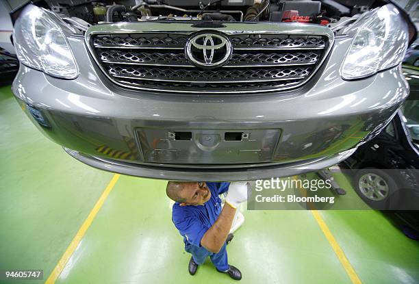 Mechanic repairs a Toyota Motor Corp. Vehicle at the company's dealership in Singapore, on Tuesday, May 8, 2007. Toyota Motor Corp., the world's...