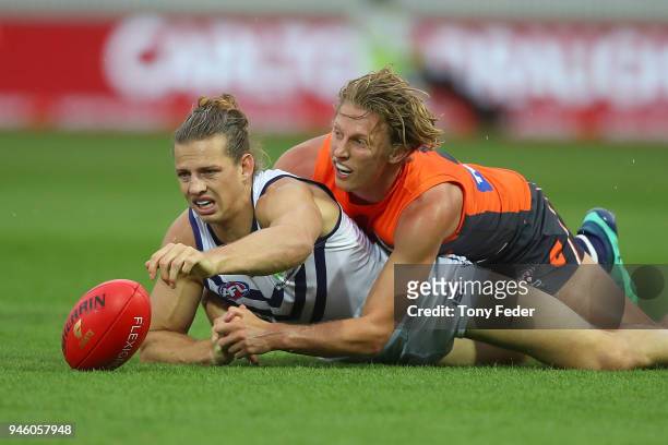 Nat Fyfe of the Dockers is tackled by Lachie Whitfield of the Giants during the round four AFL match between the Greater Western Sydney Giants and...