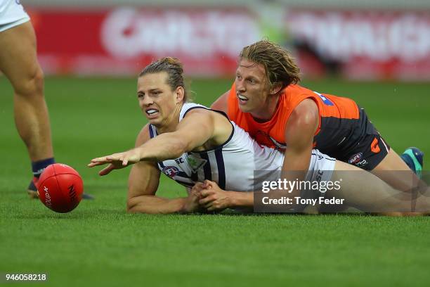 Nat Fyfe of the Dockers is tackled by Lachie Whitfield of the Giants during the round four AFL match between the Greater Western Sydney Giants and...