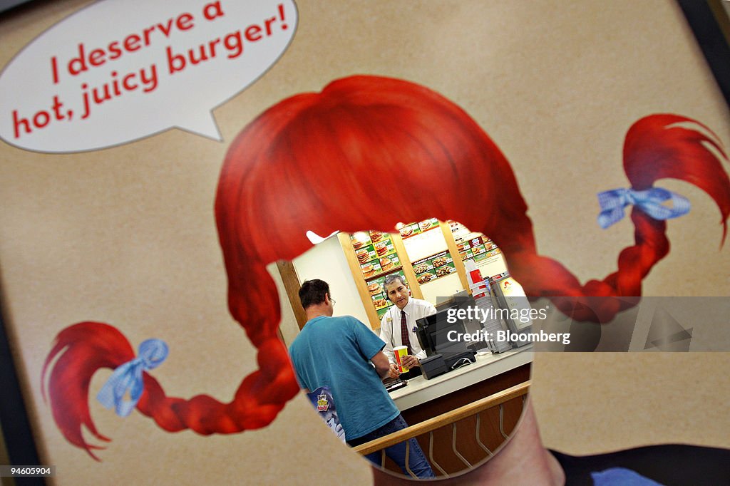 Viewed through the opening of a promotional poster, manager