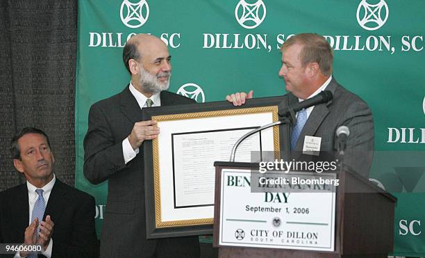 Dillon Representative Jackie Hayes, right, gives U.S. Federal Reserve Chairman Ben S. Bernanke, center, a proclamation stating that September 1, 2006...